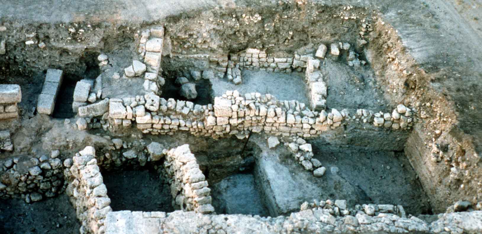 General view - Iron Age structures (with several phases of floor levels and later foundations (Persian - Roman) superimposed. Note for instance the ashlar-built Roman drainage channel of the Cardo at back left