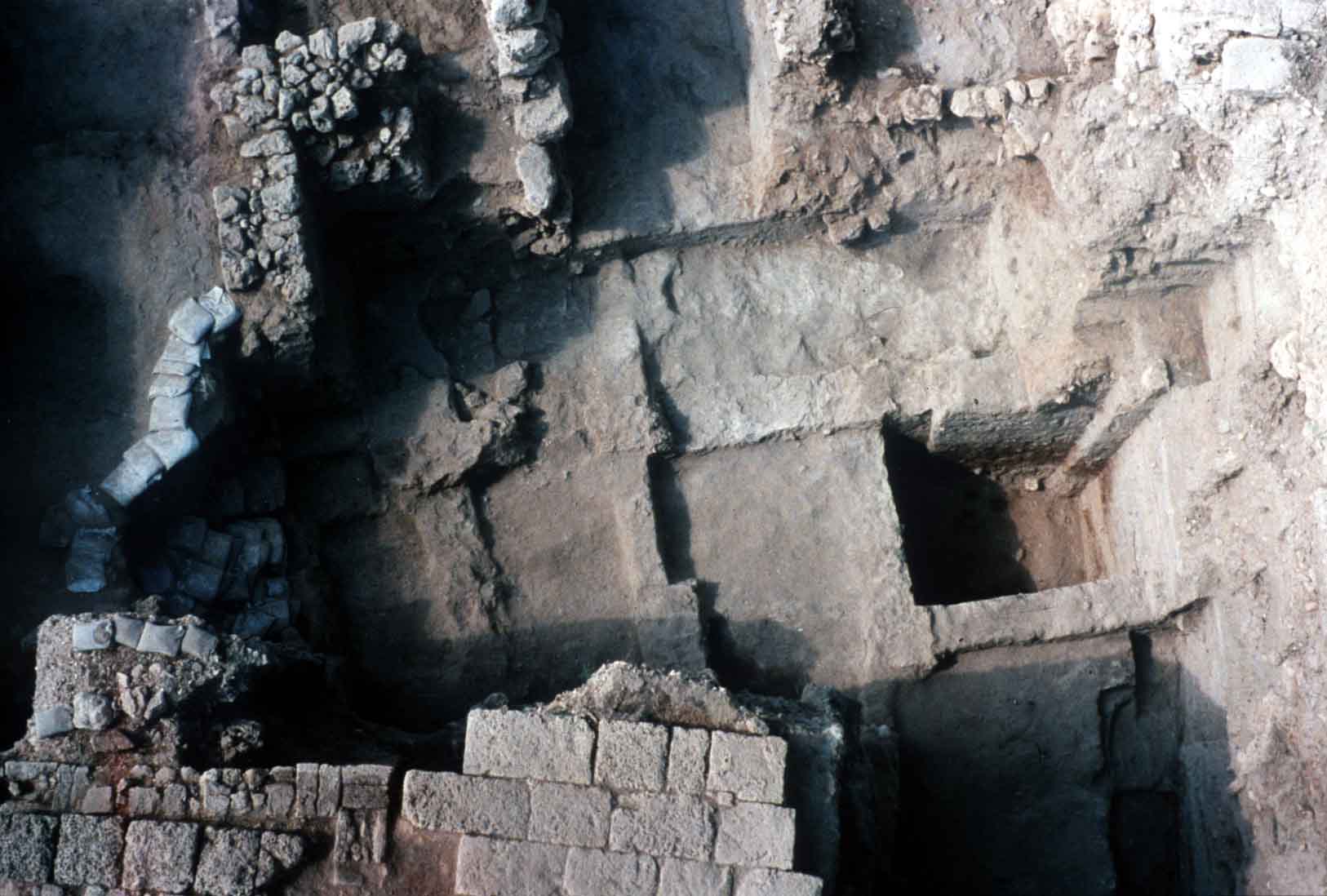 Late Bronze Age and transitional surfaces under Iron Age houses (back) Roman pavement on top, front